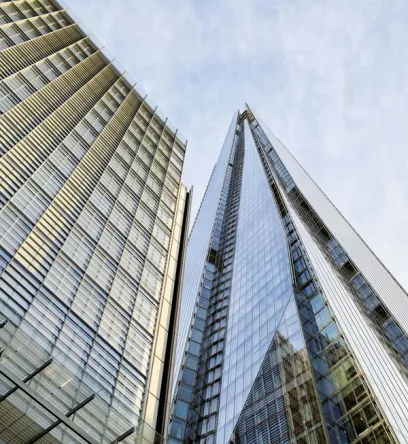 looking up at a group of tall buildings with a blue sky in the background