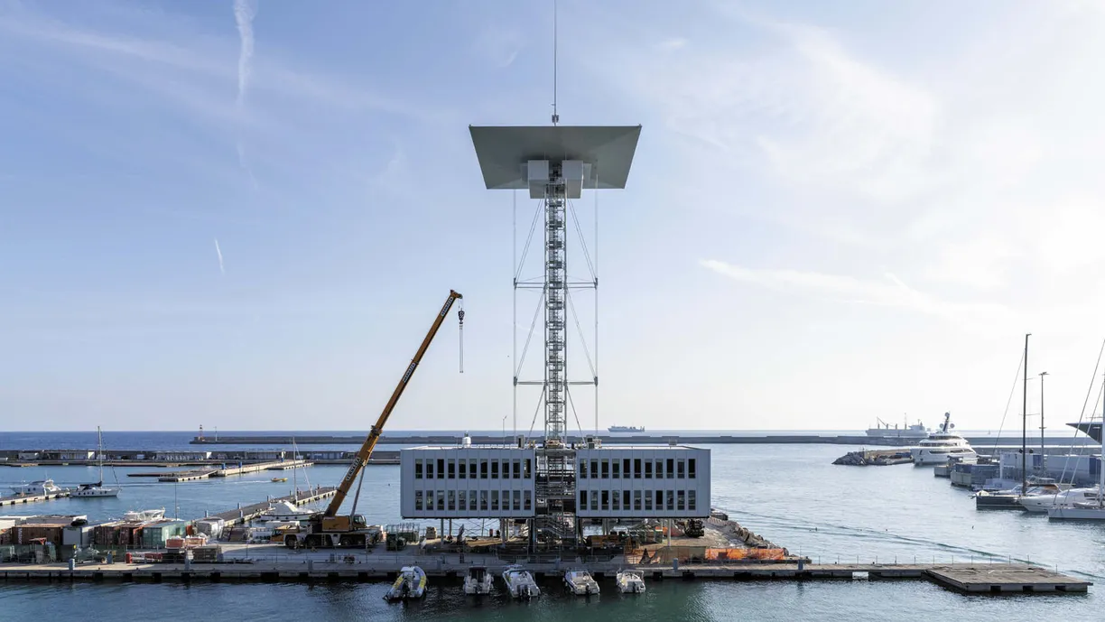 a large building is being built in the middle of a harbor .