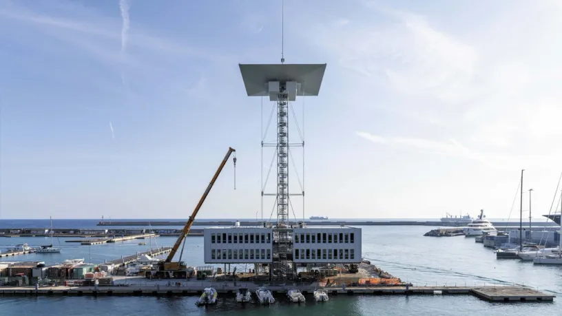 a large building is being built in the middle of a harbor .