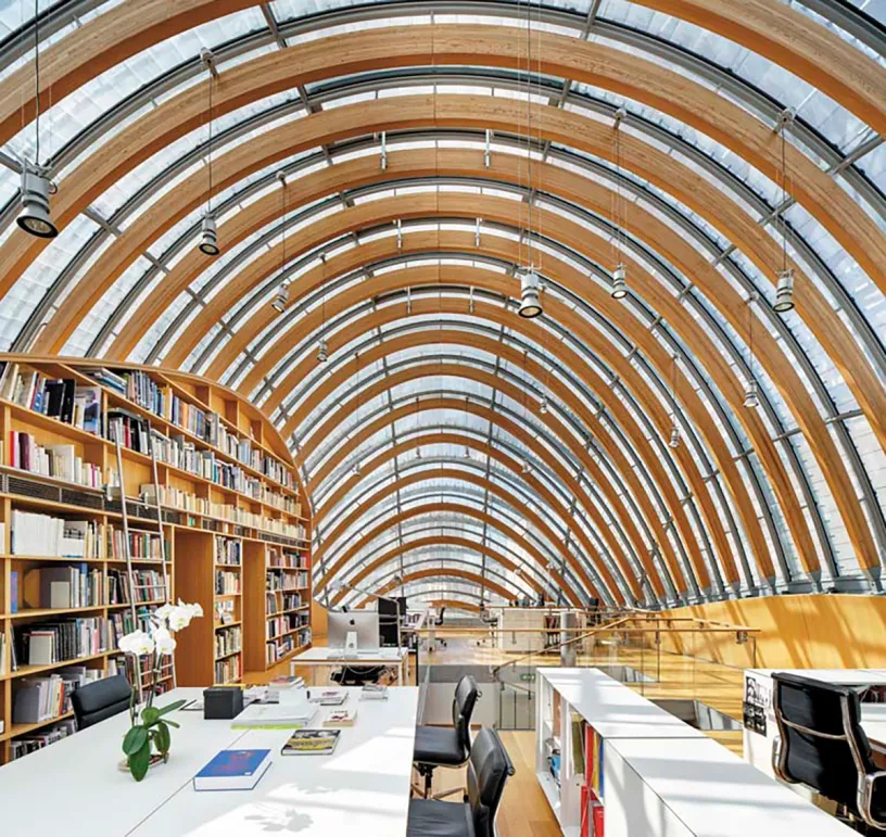 A library with a curved ceiling and lots of books on shelves