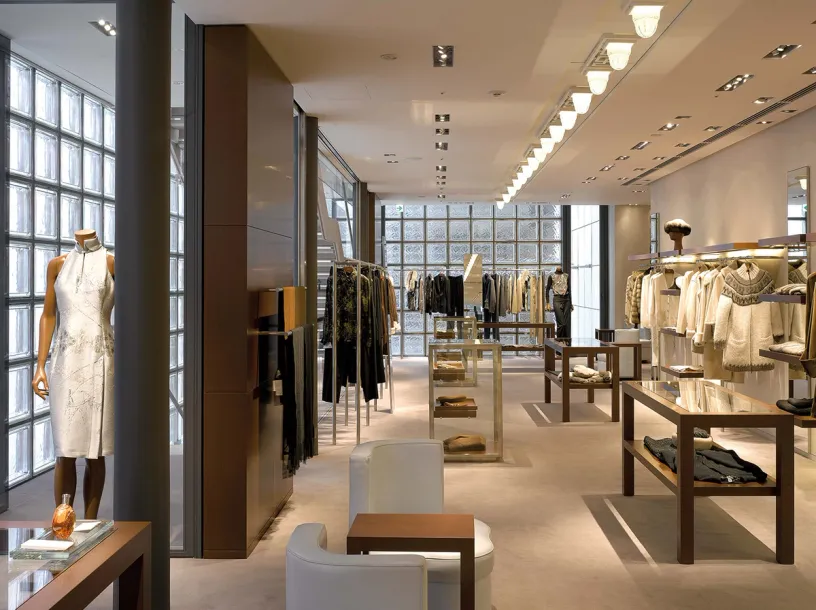 A large clothing store with a lot of clothes on display