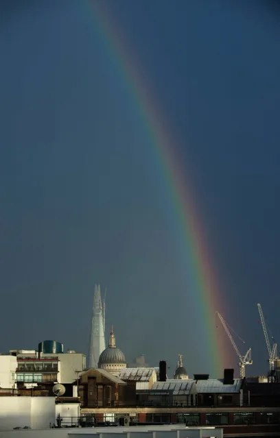 A city skyline with a rainbow in the sky