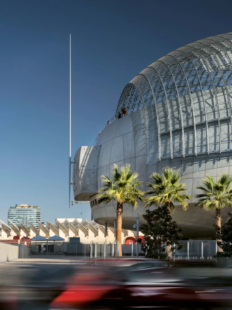 A large building with palm trees in front of it
