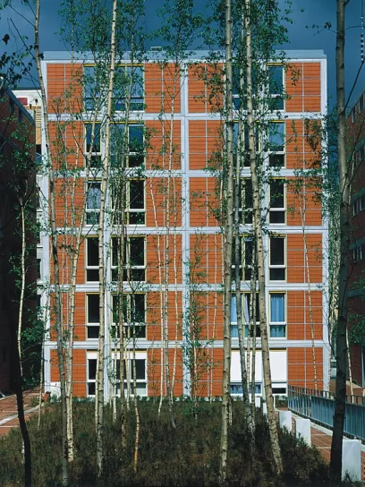 a building with a lot of windows and trees in front of it