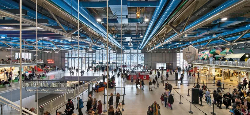 A large building with a lot of people walking around it