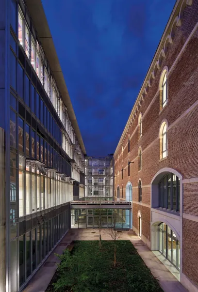 A building with a lot of windows and a brick wall