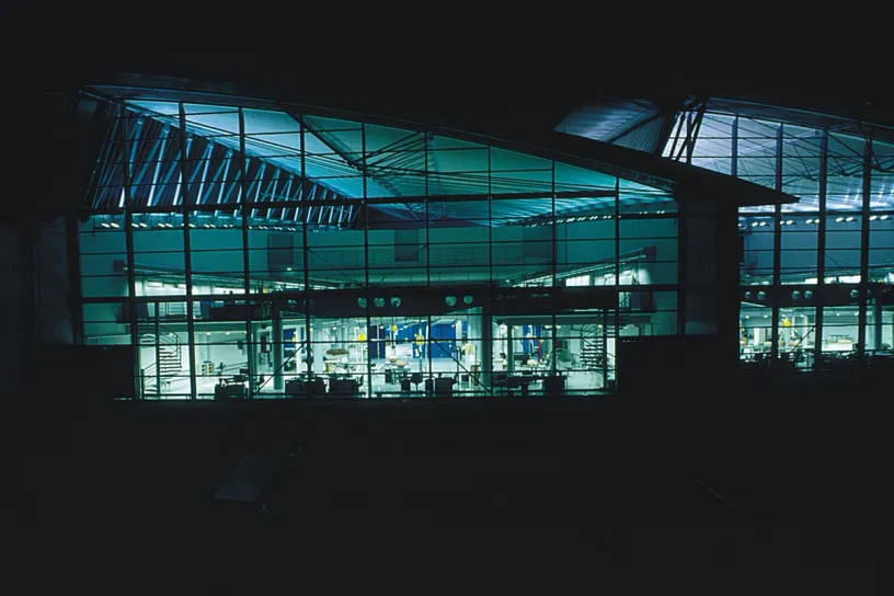A large building with a lot of windows is lit up at night