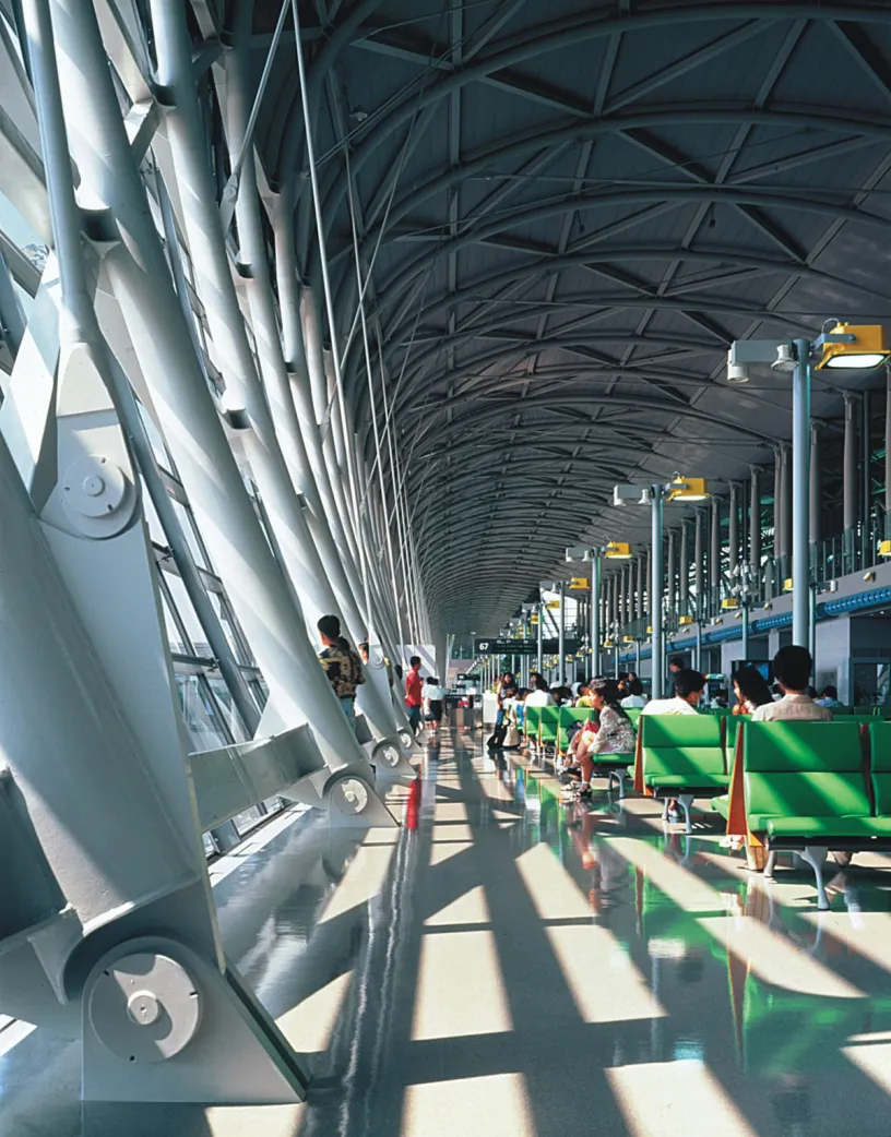 A row of green seats in an airport waiting area
