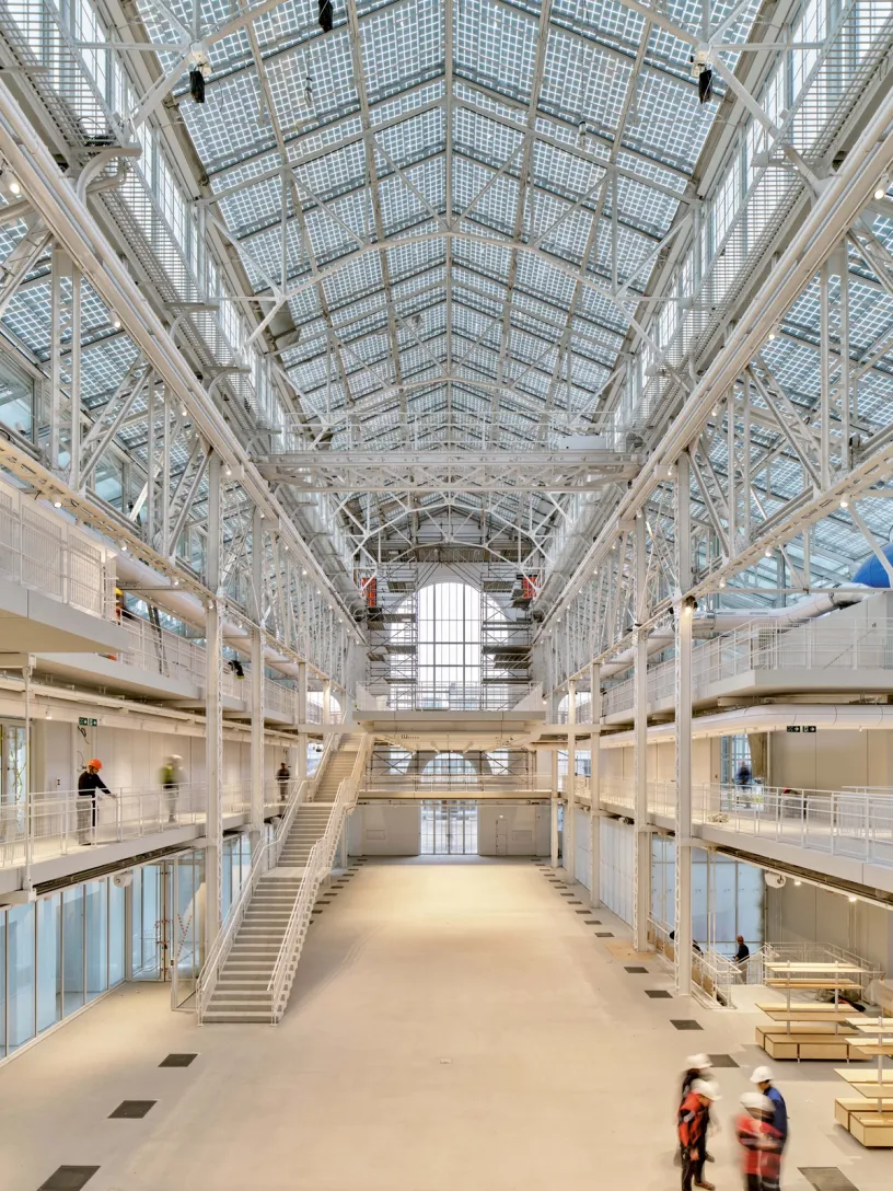 a large building with stairs and a clear roof