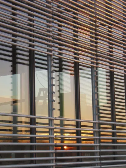 the sun is reflected in the windows of a building .