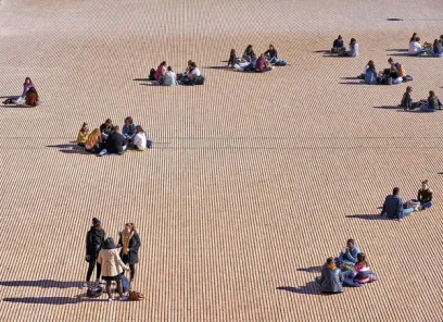 A group of people are sitting on a wooden floor