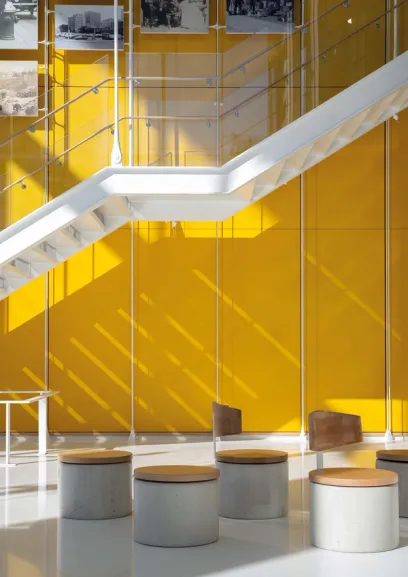 A white staircase with a yellow wall behind it