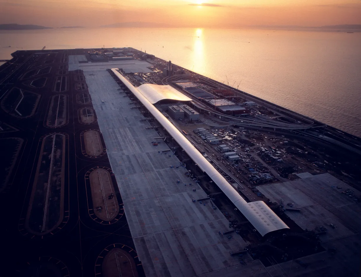 an aerial view of an airport runway at sunset