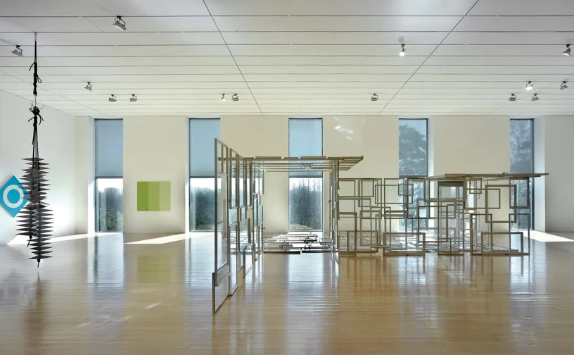 A large room with a lot of windows and a wooden floor