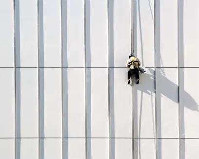 A man is climbing up the side of a building