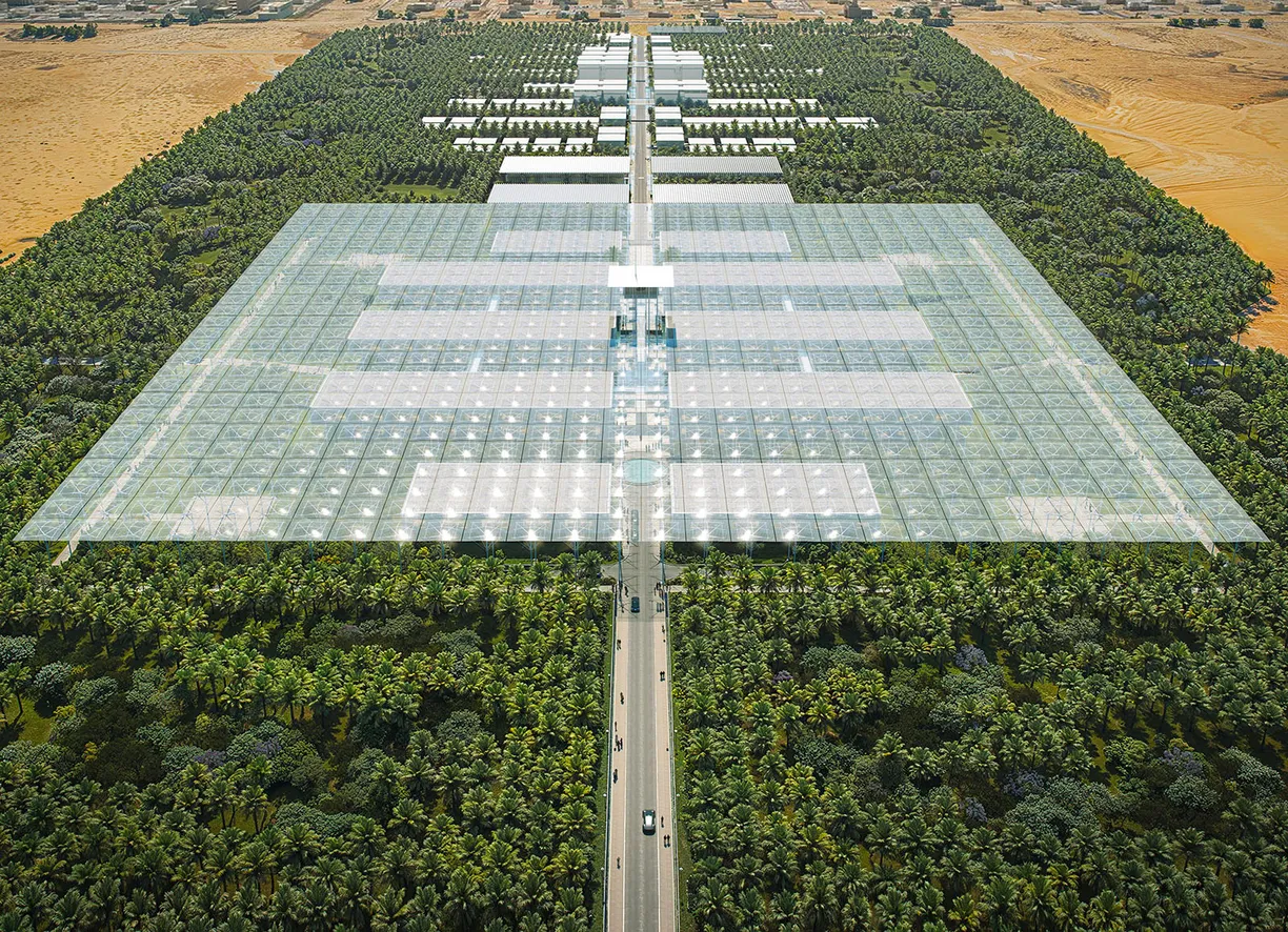 an aerial view of a large building surrounded by trees and a road .