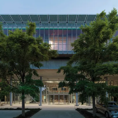 A building with a lot of windows and solar panels on the roof
