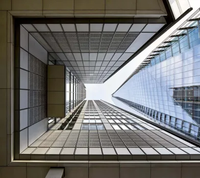 looking up at a tall building with a lot of windows .