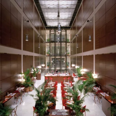 A restaurant with tables and chairs in a large building