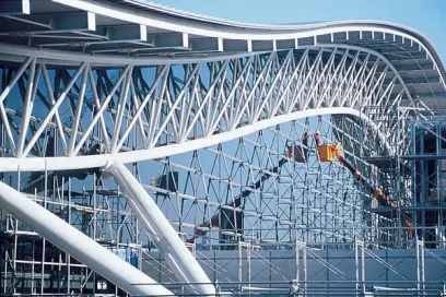 A large metal structure is being built on top of a building