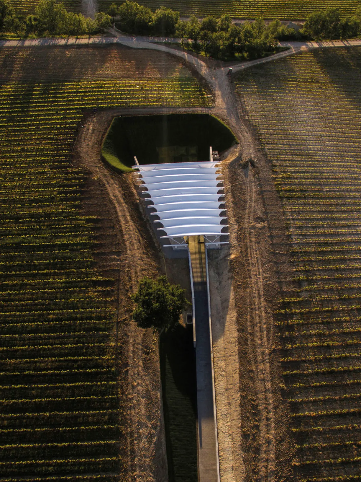 an aerial view of a building in the middle of a field