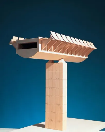A light wood architectural model featuring a tall rectangular base supporting a curved horizontal structure with an opening and a row of curved fins.