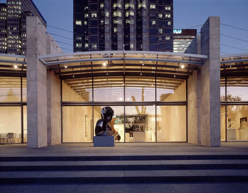 the entrance to a museum with a statue in front of it