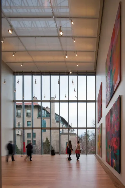 A group of people looking at paintings in a museum