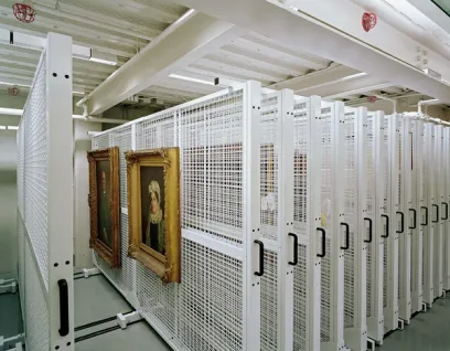A row of shelves filled with paintings in a museum