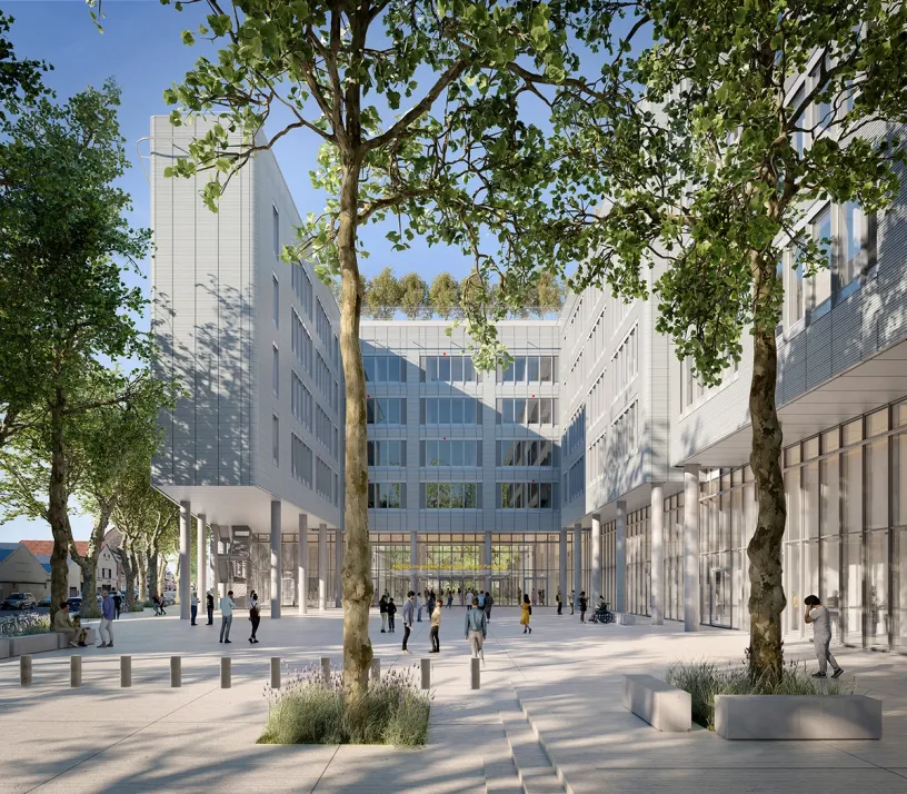 Modern building complex surrounding a public plaza with people, trees, and a green roof.