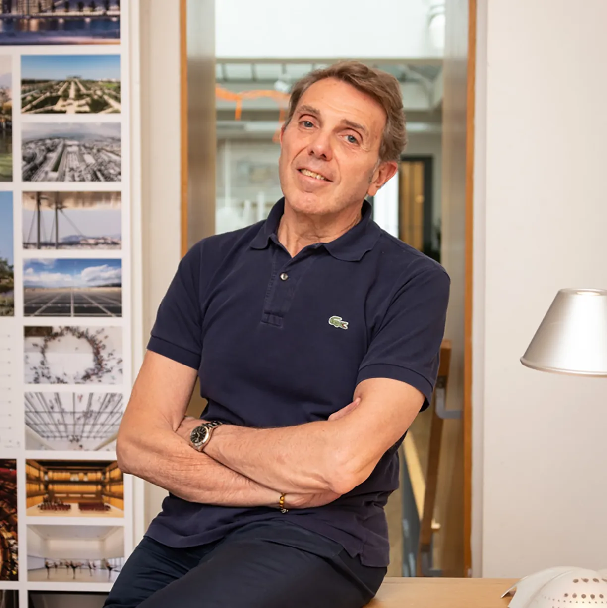 A man wearing a blue polo shirt with a lacoste logo on it