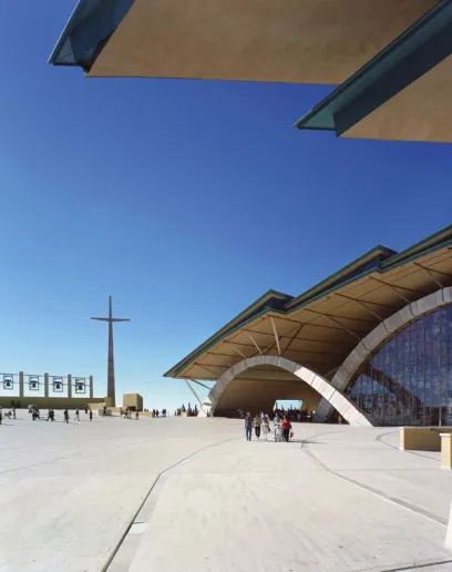 A large building with a large cross in the background