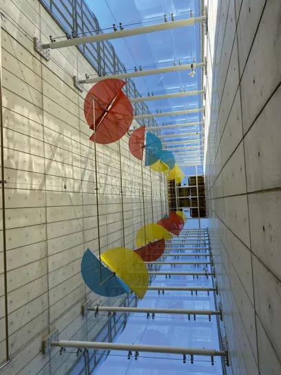 a row of colorful umbrellas hanging from the ceiling of a building