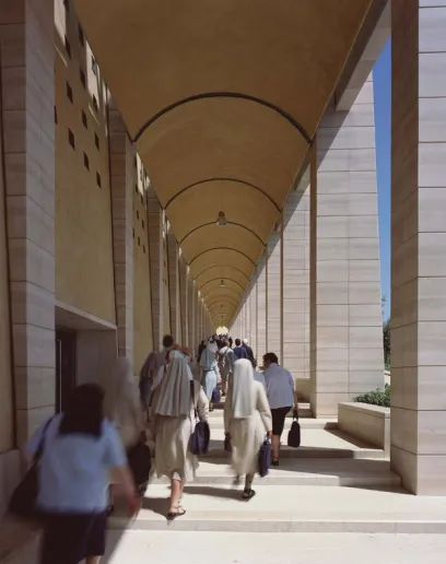 A group of nuns are walking down a hallway