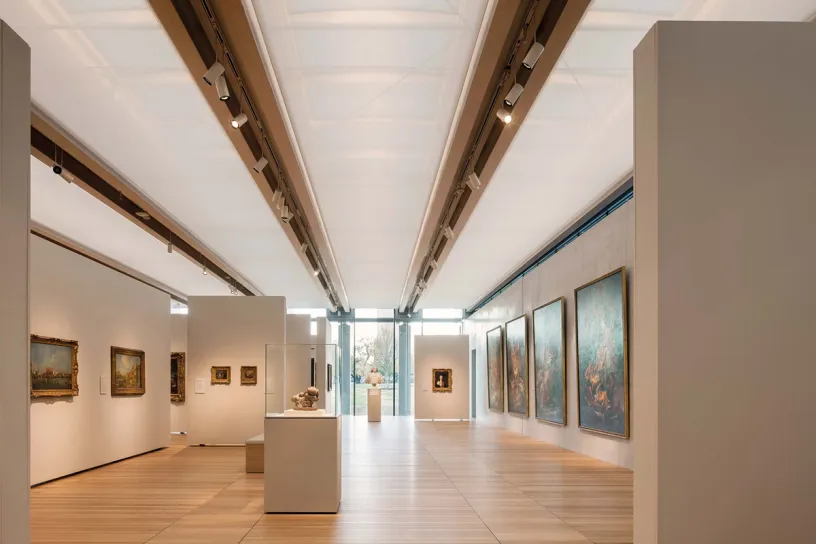 A large museum filled with lots of paintings and sculptures