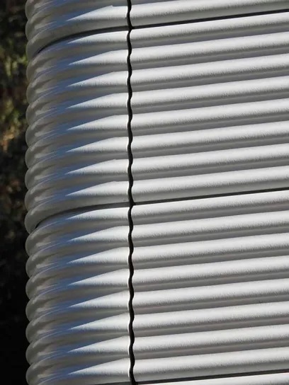 A close up of a stack of corrugated metal pipes