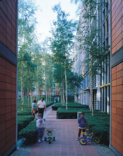 a boy riding a bike in a park with other people