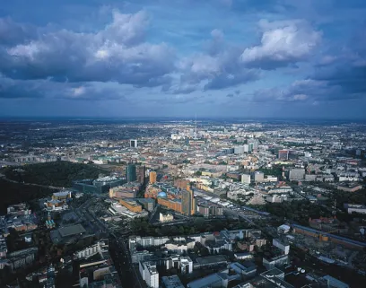An aerial view of a city with lots of buildings and clouds in the sky