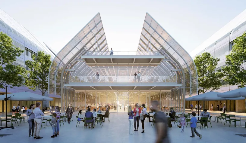 A group of people are sitting at tables outside of a building