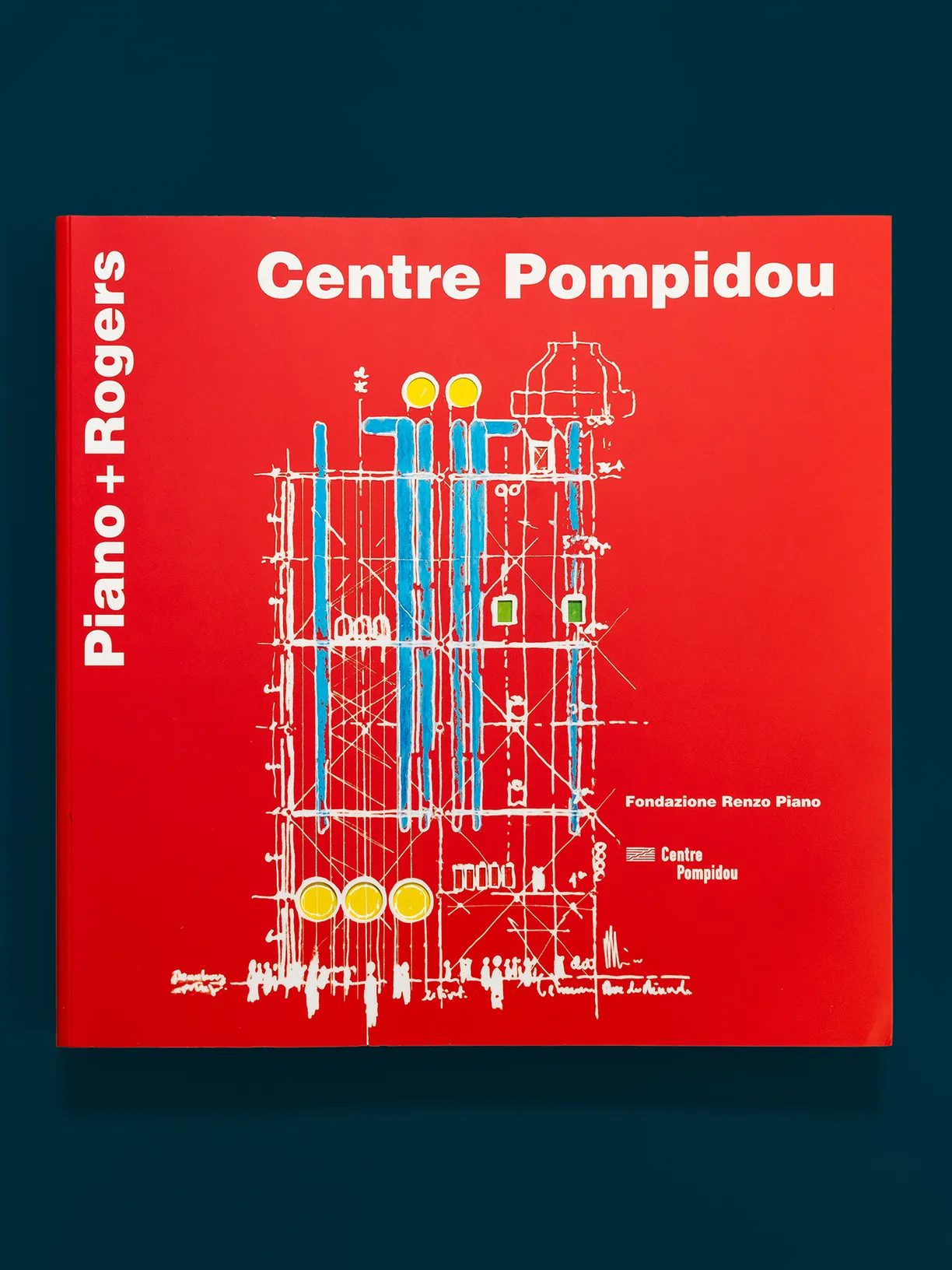 a red book titled centre pompidou by piano + rogers