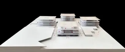 White architectural model of a multi-layered building complex with small red figures, against a black background.