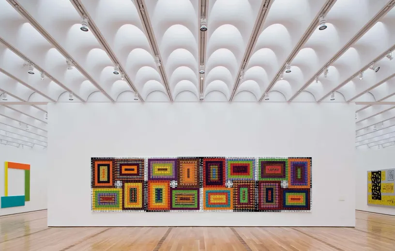 A large room with a lot of paintings on the wall