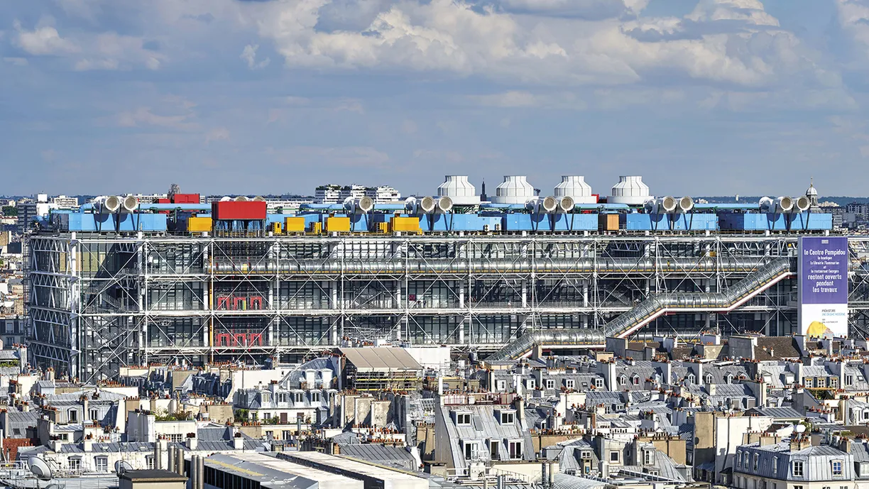 An aerial view of a large building in the middle of a city