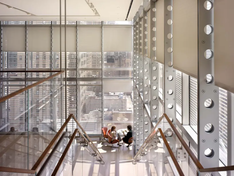 a group of people are sitting on the stairs of a building