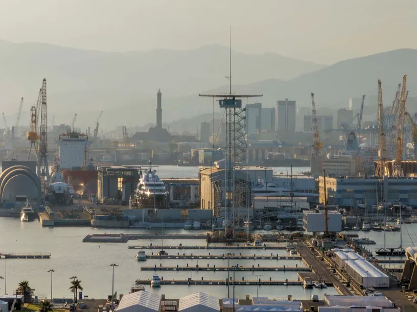 An aerial view of a harbor filled with lots of boats and cranes