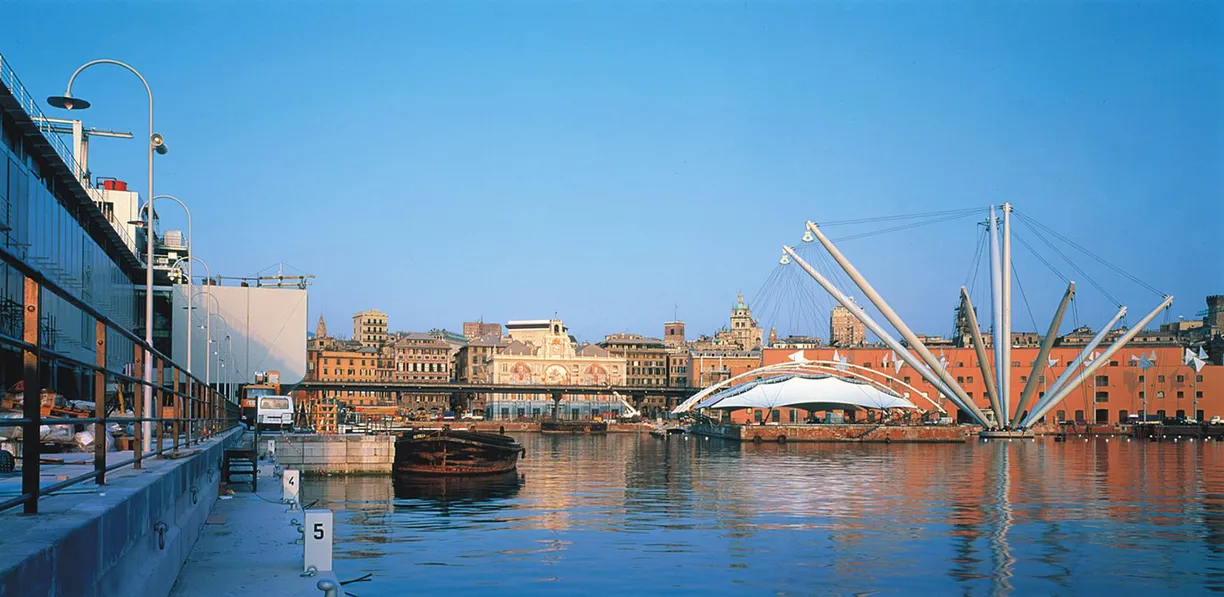 A bridge over a body of water with a city in the background