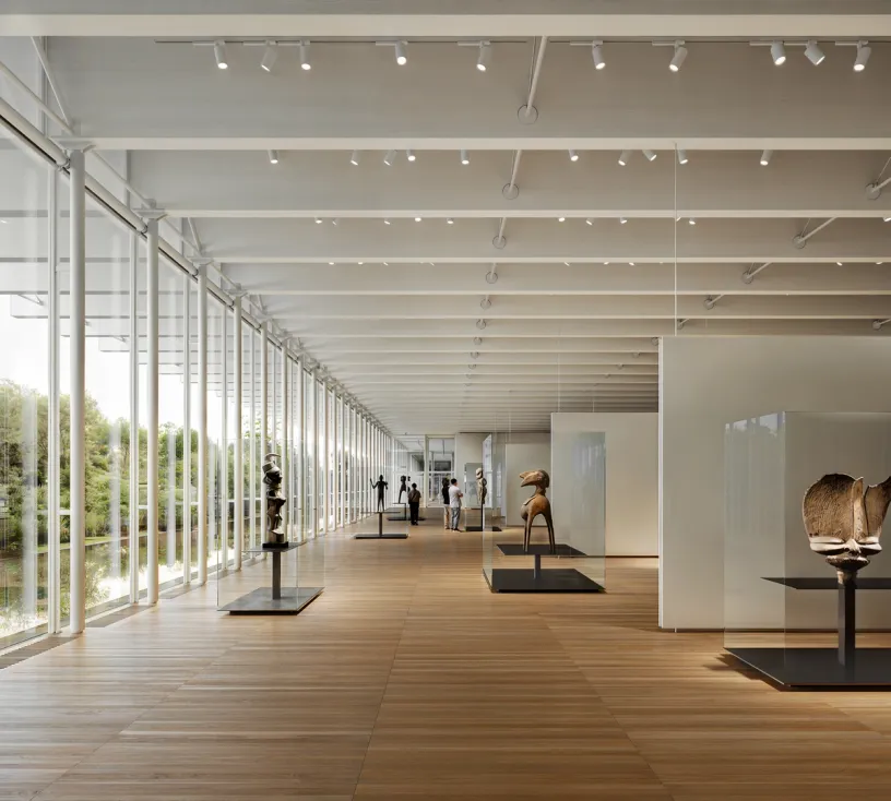 a large room with a lot of windows and sculptures on display .