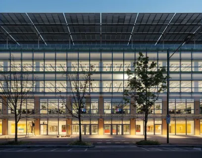 A large building with a lot of windows and solar panels on the roof
