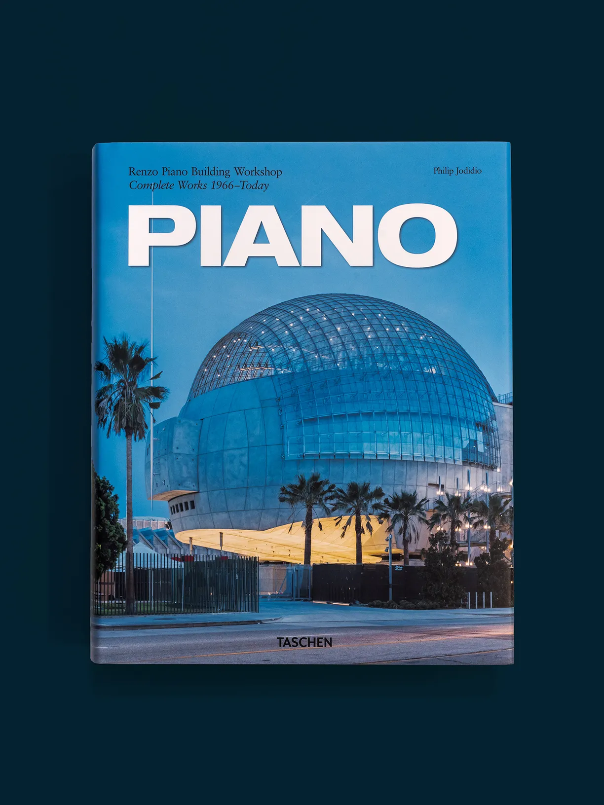A book titled piano has a picture of a building on the cover
