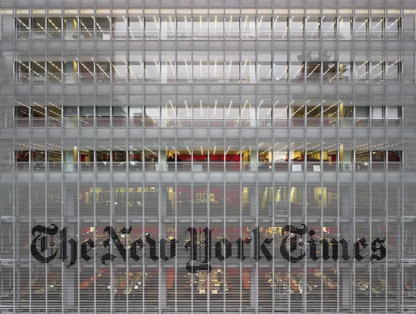 A large building with a lot of windows and the new york times written on it